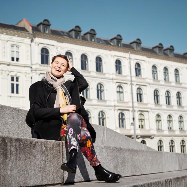 Portrait of Tanja Vidic seated in an urban square