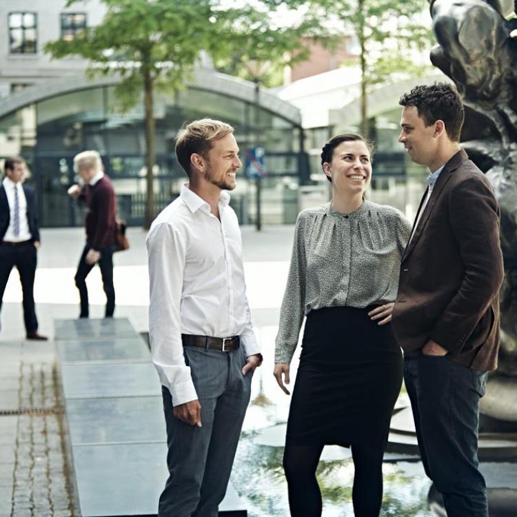 Three MBA participants talking outside the MBA building.