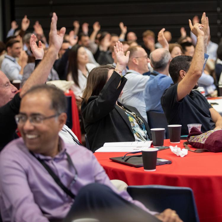 Group of people raising hands