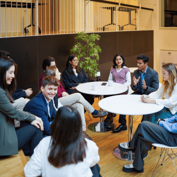 MBA students talking together around tables