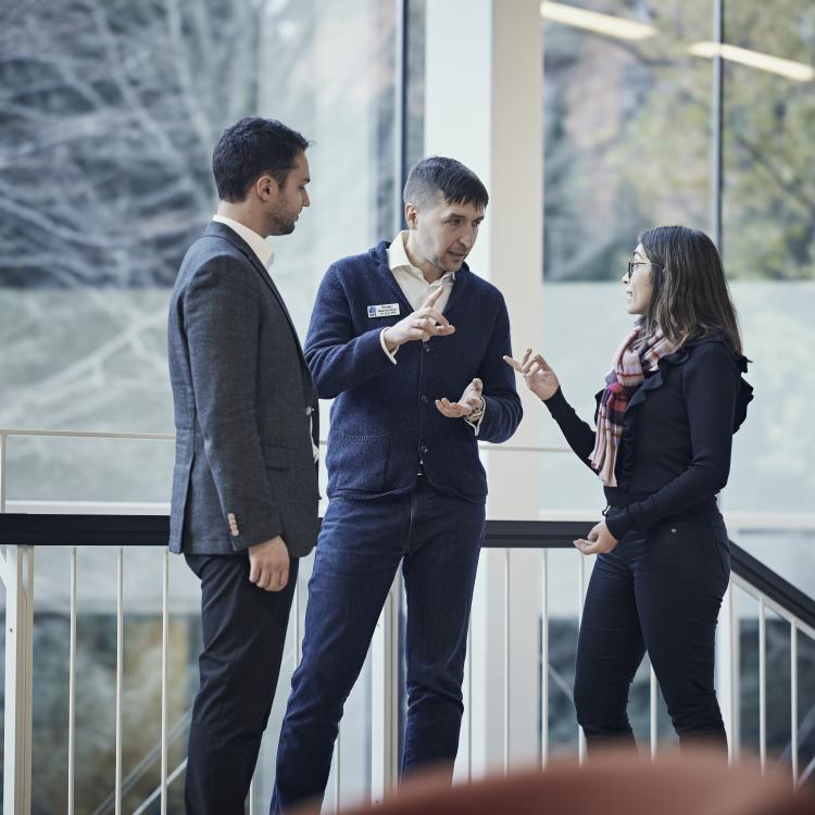 Three Blue MBA participants talking during class break