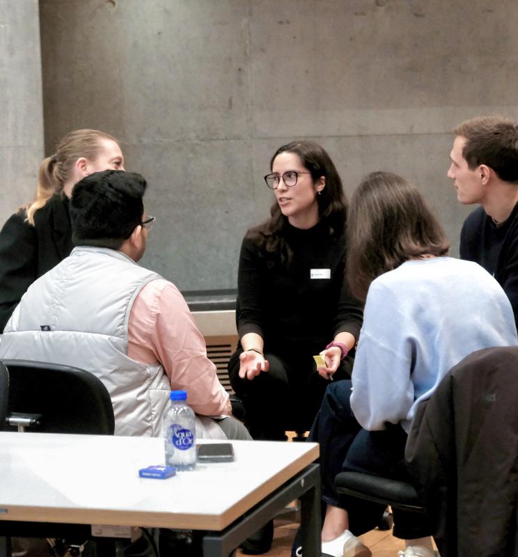 Group of participants engaged in discussion during a CBS event. 