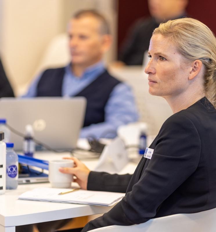 Liv Kjær, Blue MBA alumni, seated at a table during a classroom session