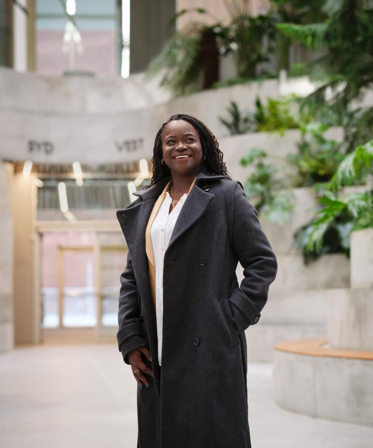 Portrait of Olufunke Ajoke Adebiyi in a modern architectural setting.