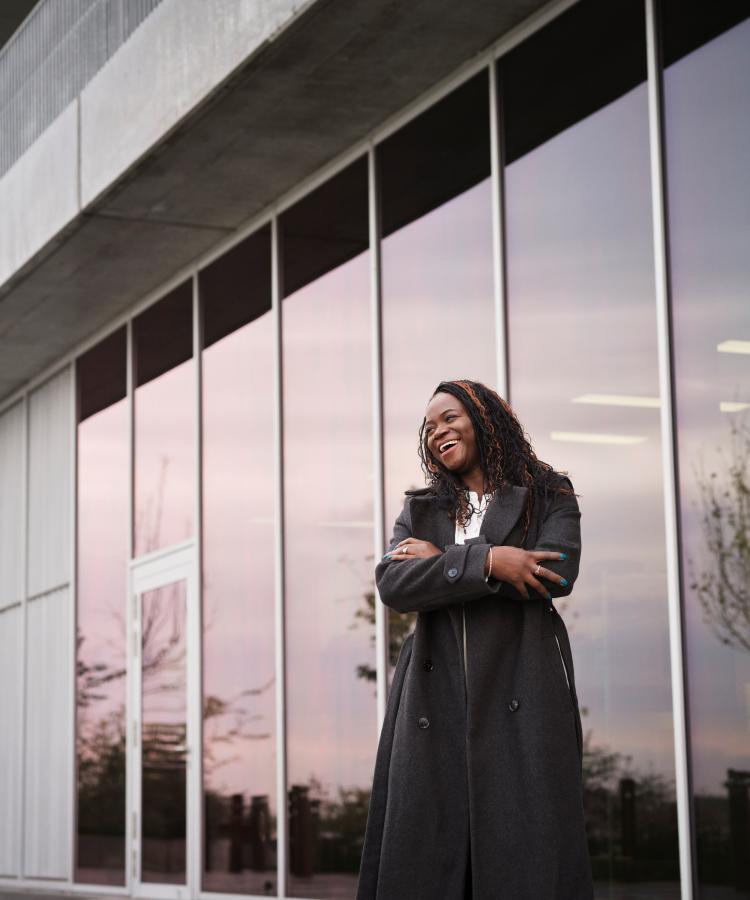 Portrait of Olufunke Ajoke Adebiyi, posing in front of modern office building