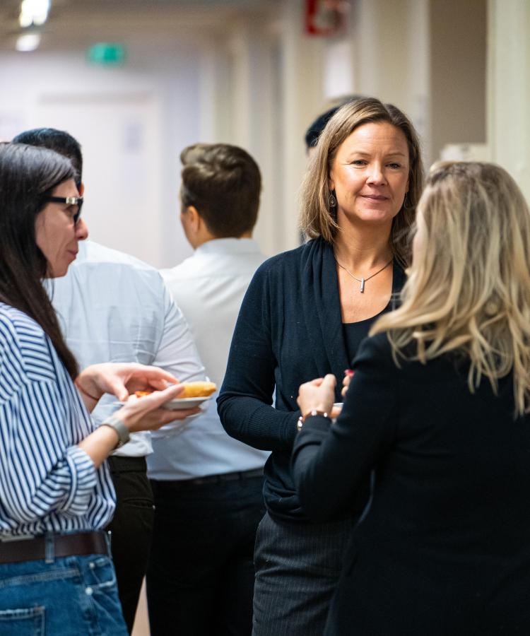 Executive MBA participants networking during lecture break