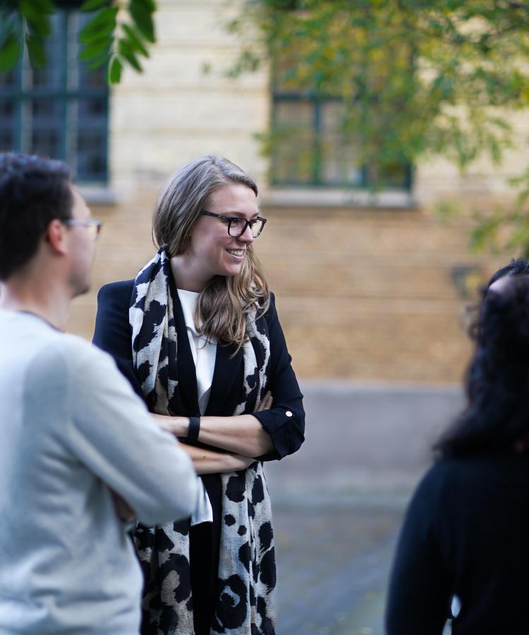 MBA students networking outside after lecture.