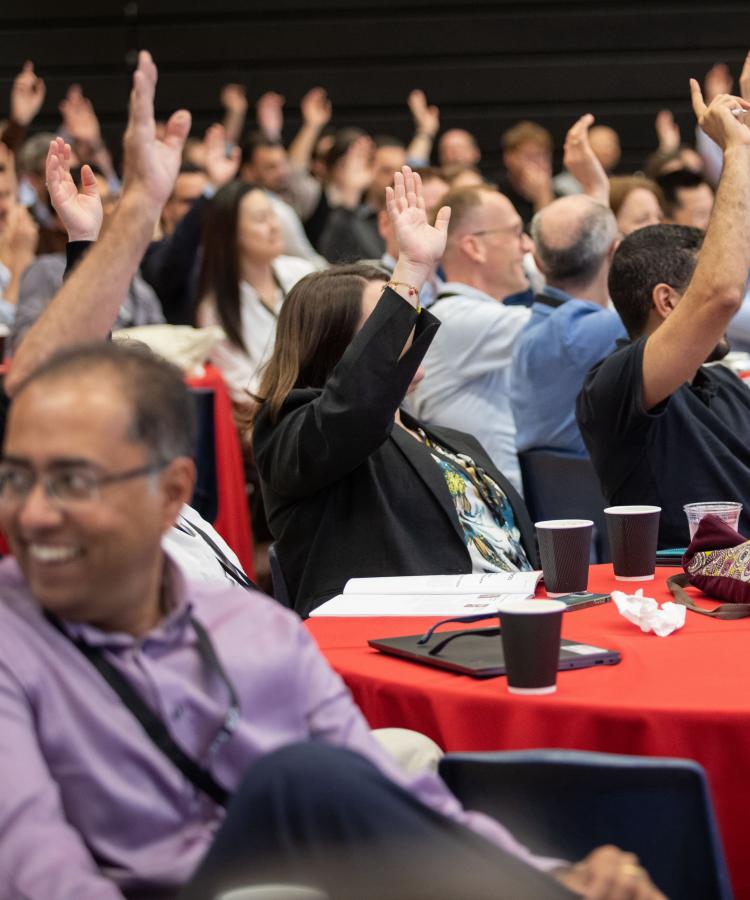 Group of people raising hands
