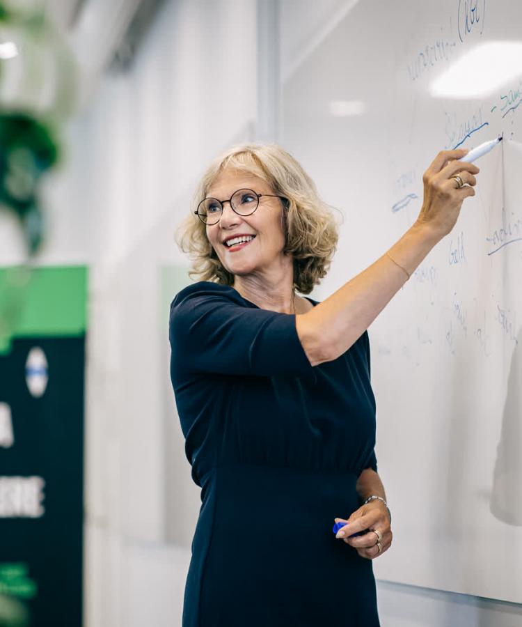 Professor Jane Bolander står ved tavle og underviser