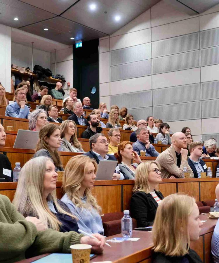 Auditorium full of listening attendees at Executive Education event, The end os ESG