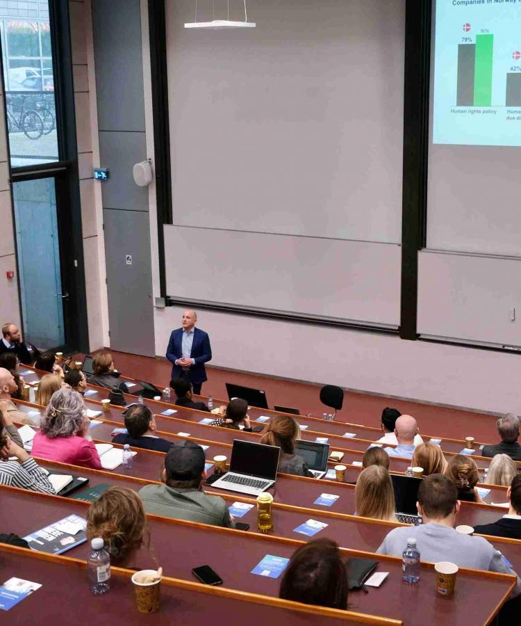 Simon Taylor speaking to auditorium full of attendees at Executive Education event, The end of ESG
