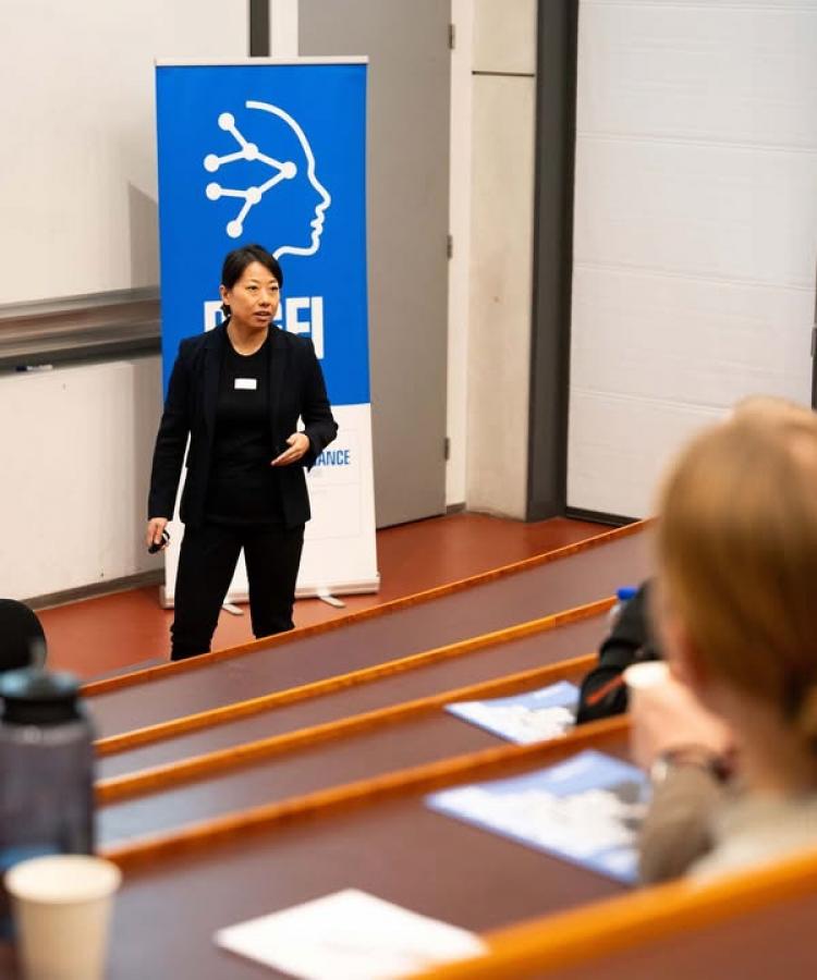 Yingjie Qi speaking at an EE event