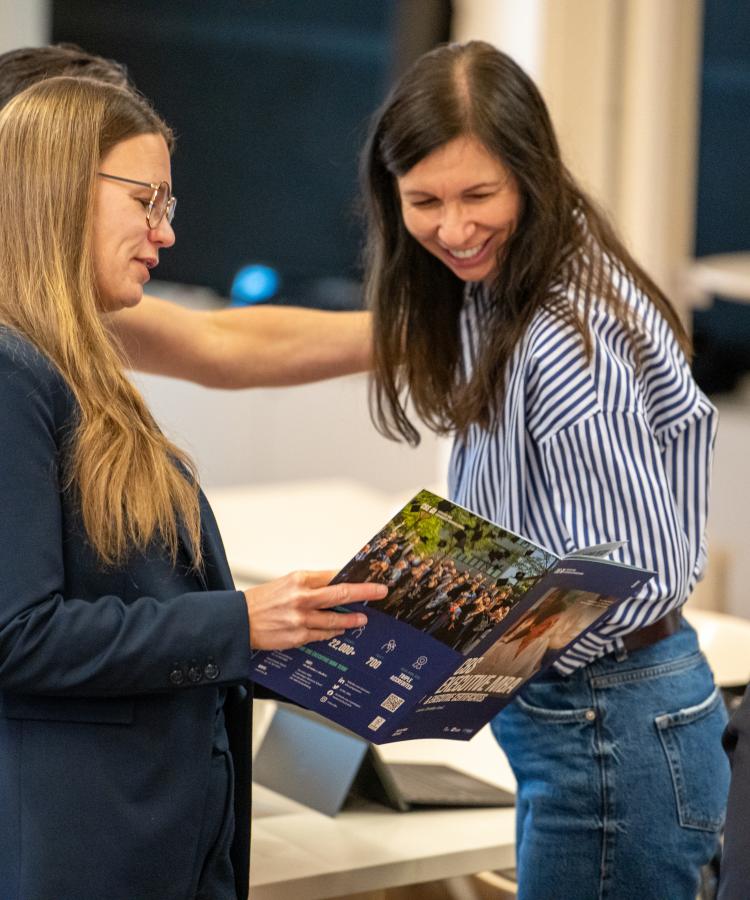 Image of CBS EMBA Participants looking at the Brochure