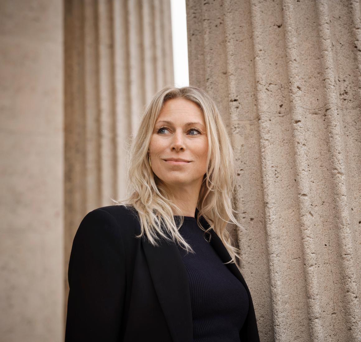 Portrait of Anna Bjerre beside classical columns