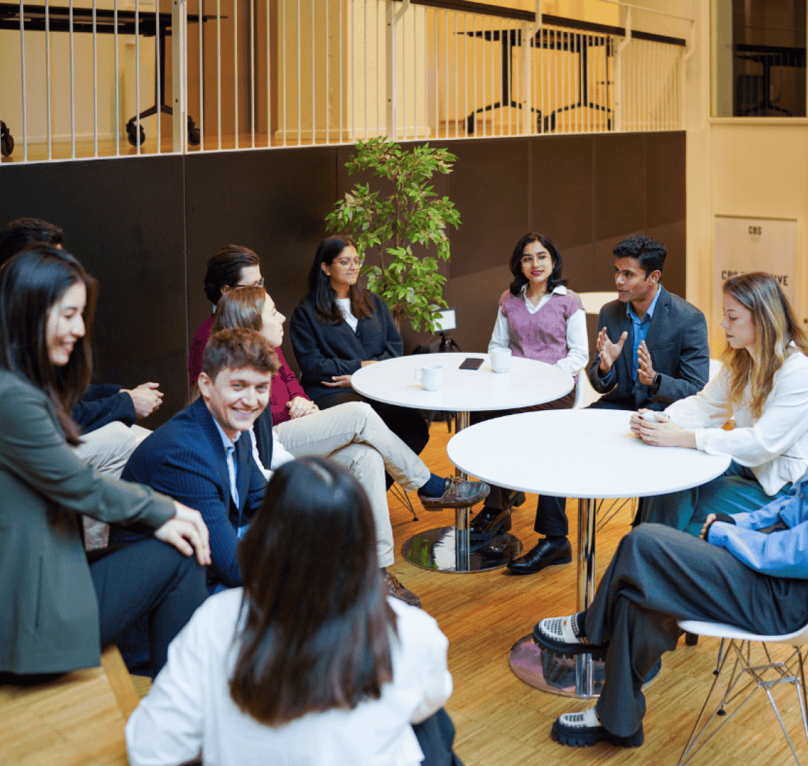 MBA students talking together around tables
