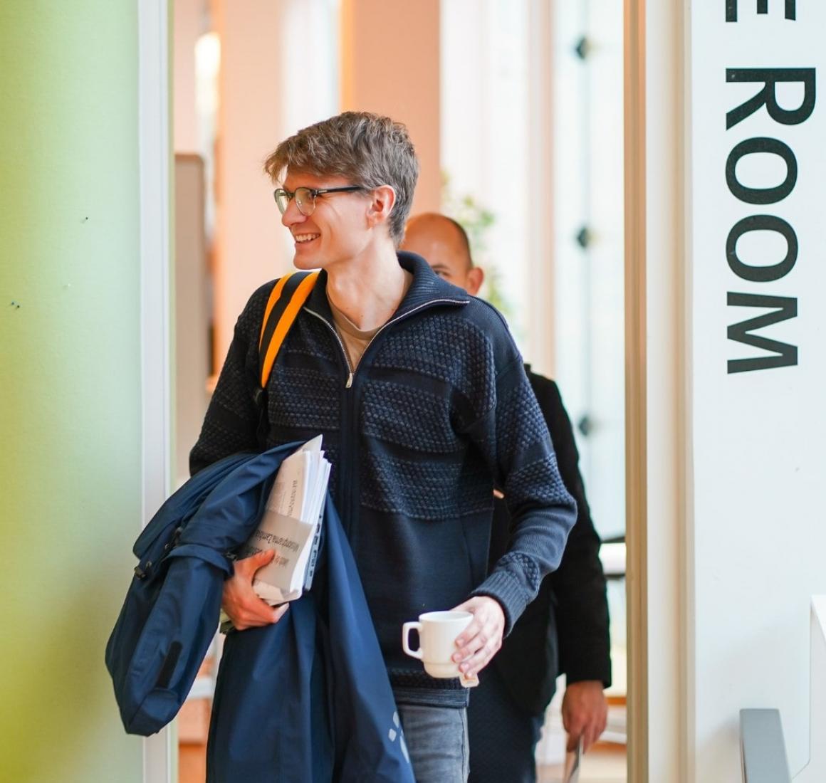 Participant from EMBA walking out of lecture room