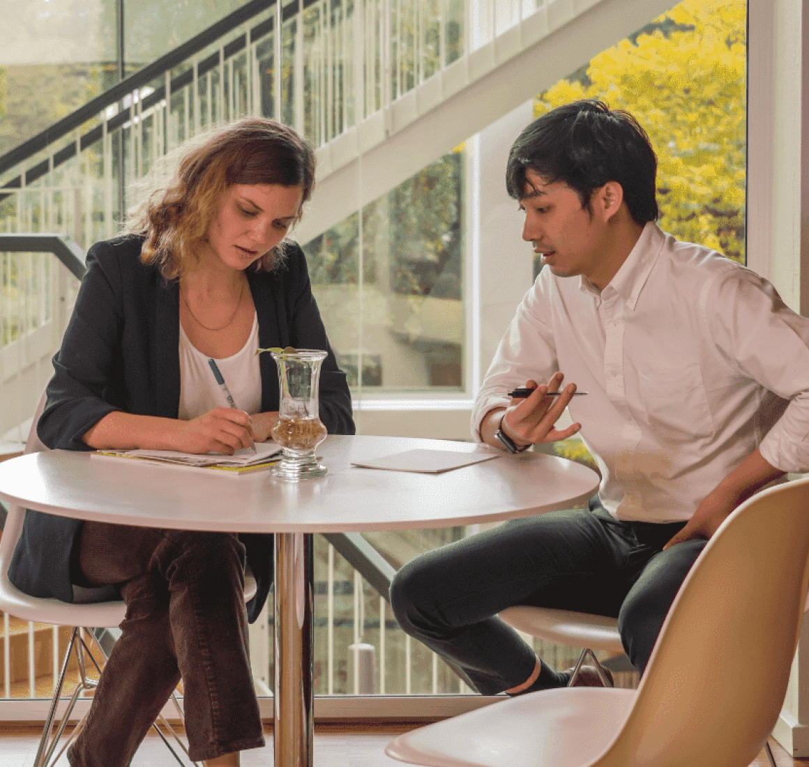 Two participants from FTMBA taking notes
