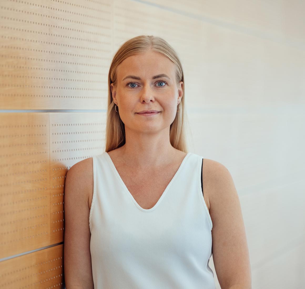 Louise Falkedal, Chief Nurse and MPG Graduate, pictured leaning against a wall at CBS