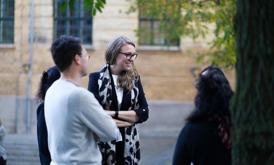 MBA students networking outside after lecture.
