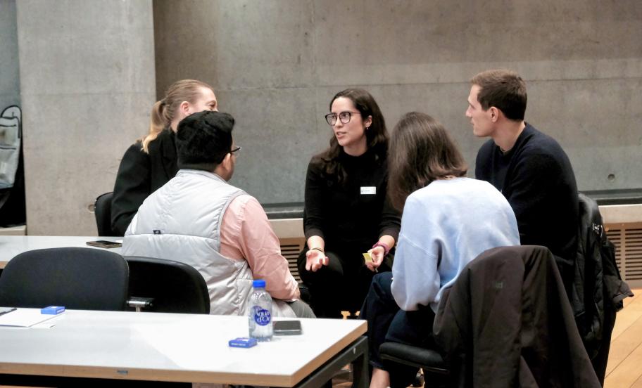 Group of participants engaged in discussion during a CBS event. 