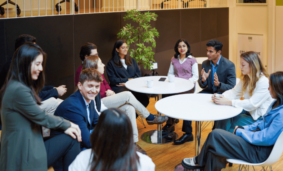 MBA students talking together around tables