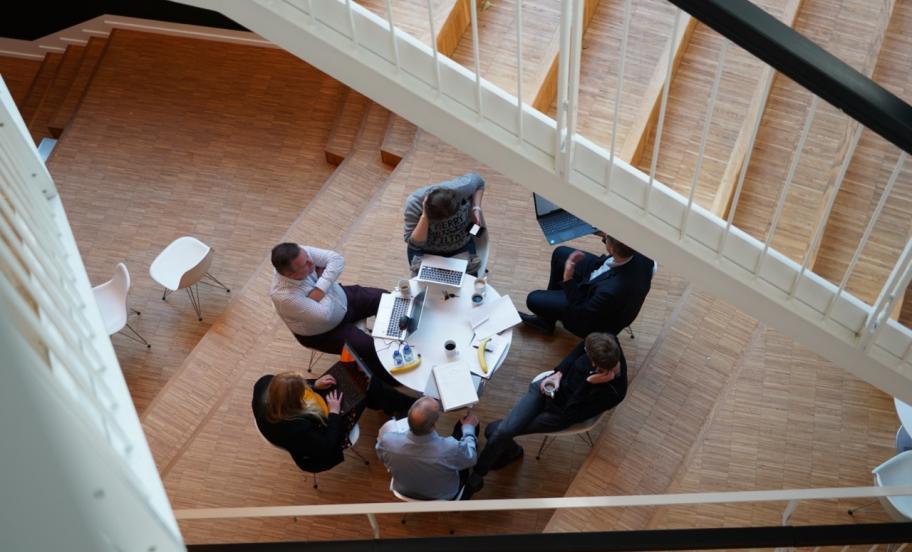 Participants at EMBA sitting around table, photographed from above
