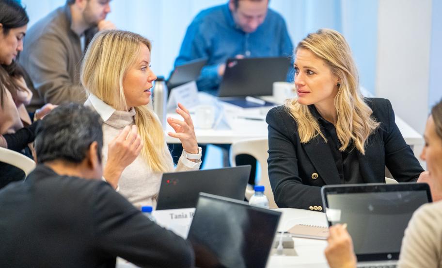 Two EMBA participants interracting in class