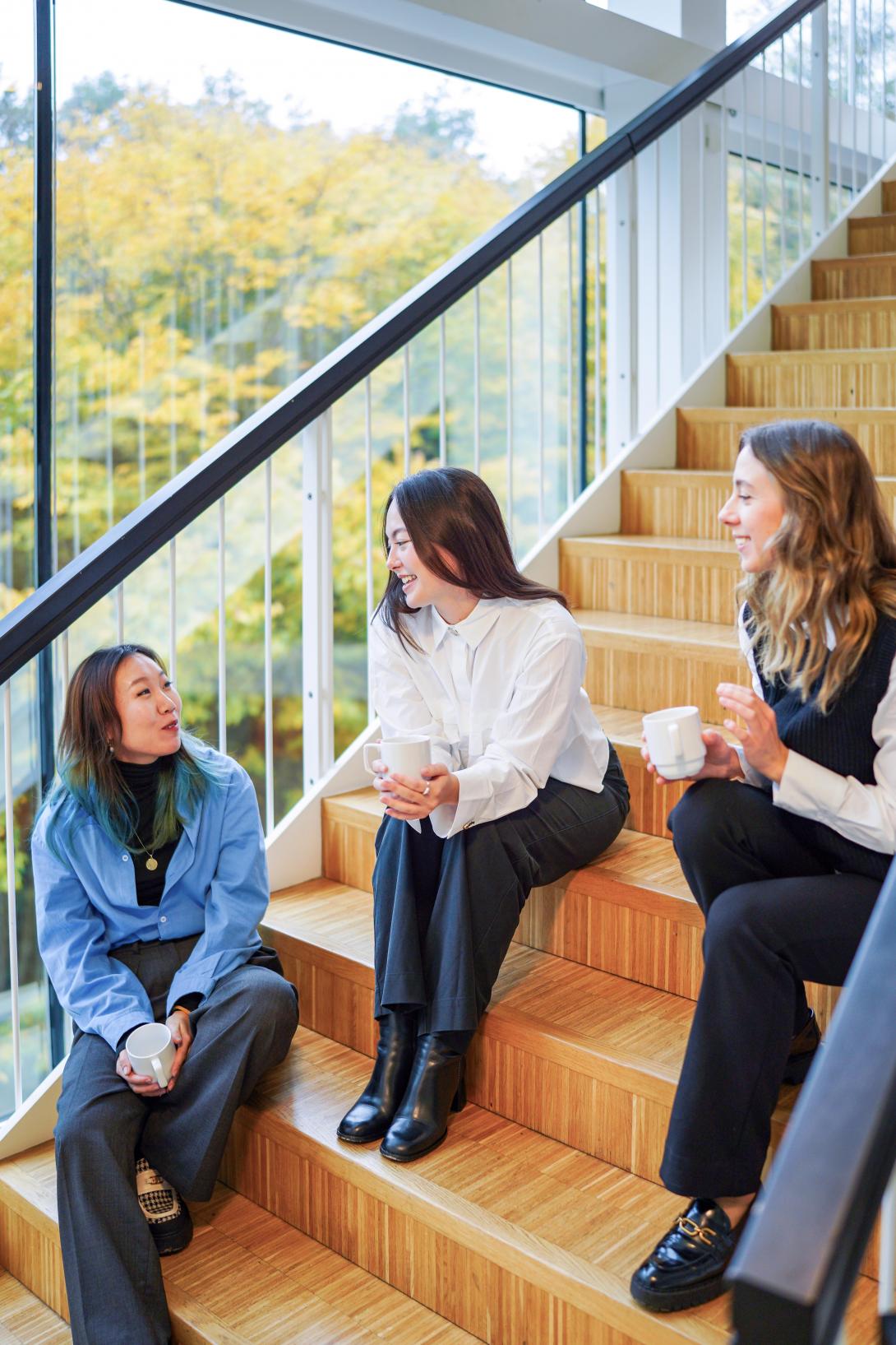 Three MBA female participants networking after class.
